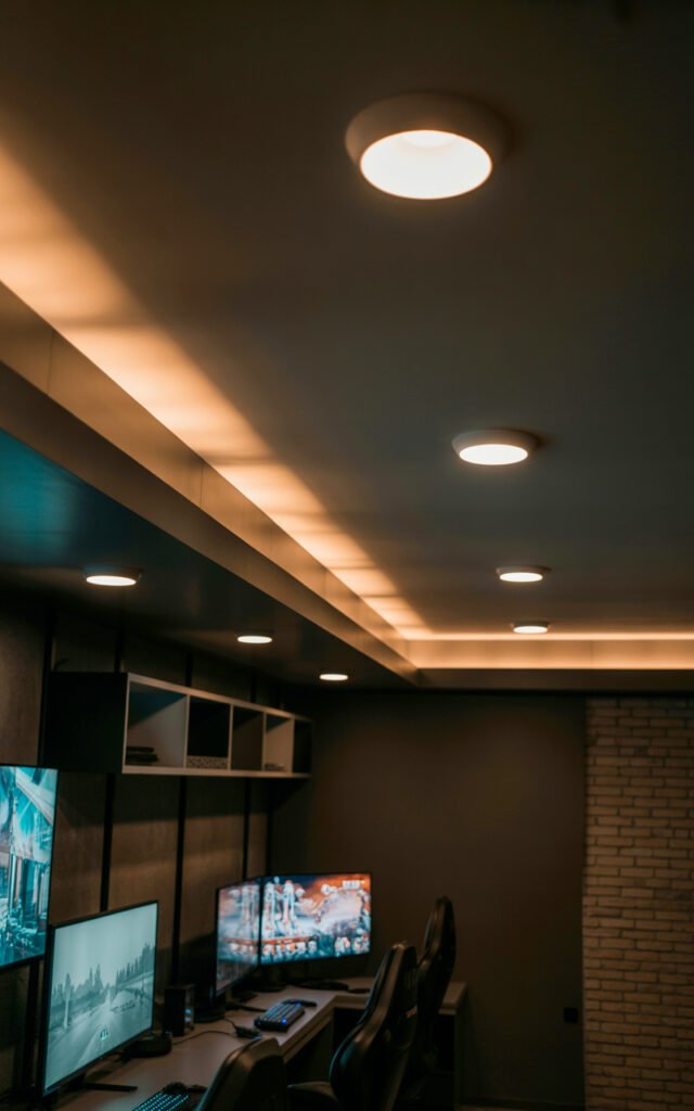 Recessed ceiling lights in dark bedroom providing proper ambient lighting for gaming setup