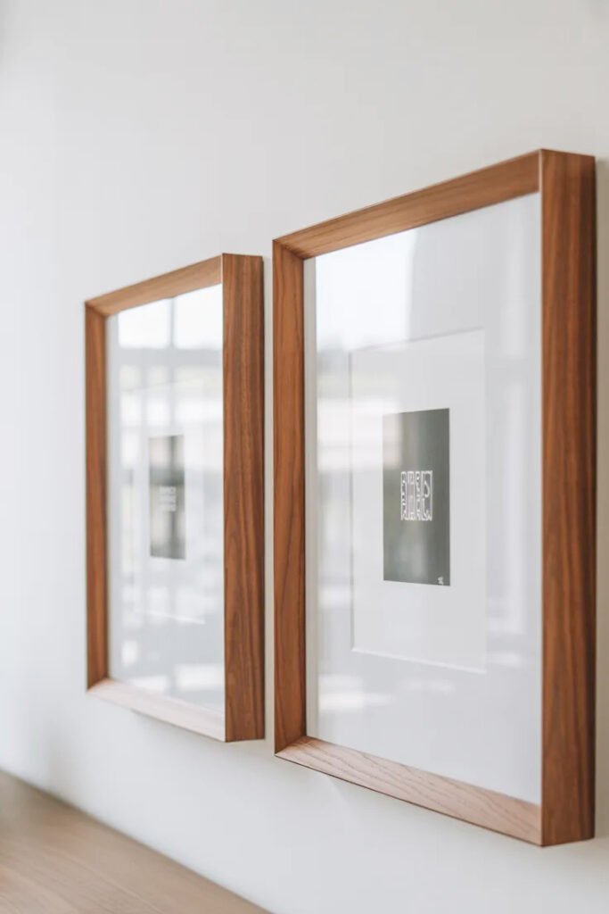 Two coordinating square frames with white mats creating symmetrical wall display