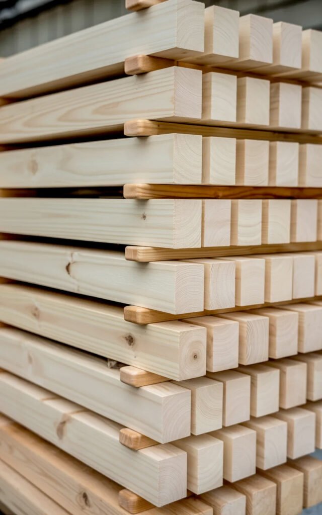 Raw pine lumber strips ready to be cut and finished for vertical slat wall project