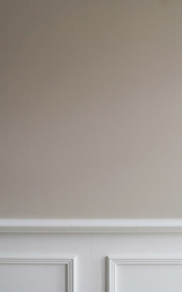 Neutral greige paint color on upper hallway walls creating elegant traditional palette