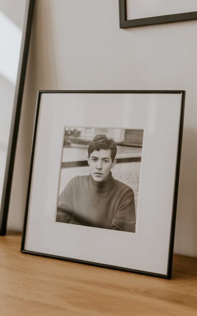 Modern black picture frame with white matting displaying black and white photograph