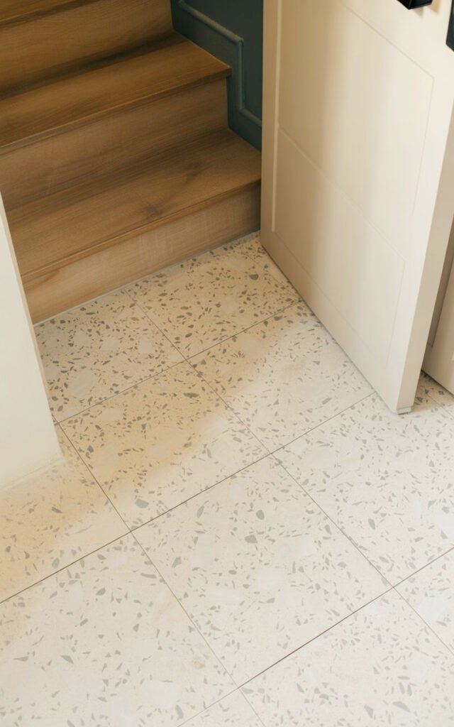 Speckled terrazzo tile floor providing durable easy-clean surface in hallway entrance
