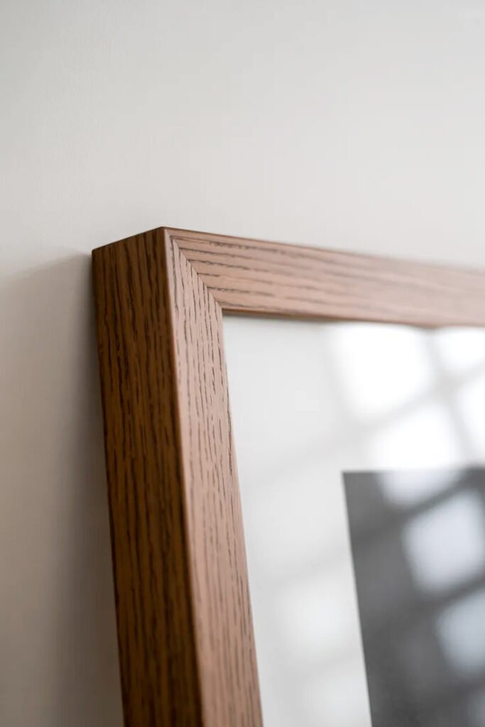 Simple wood frame molding in medium brown showing minimal modern framing style