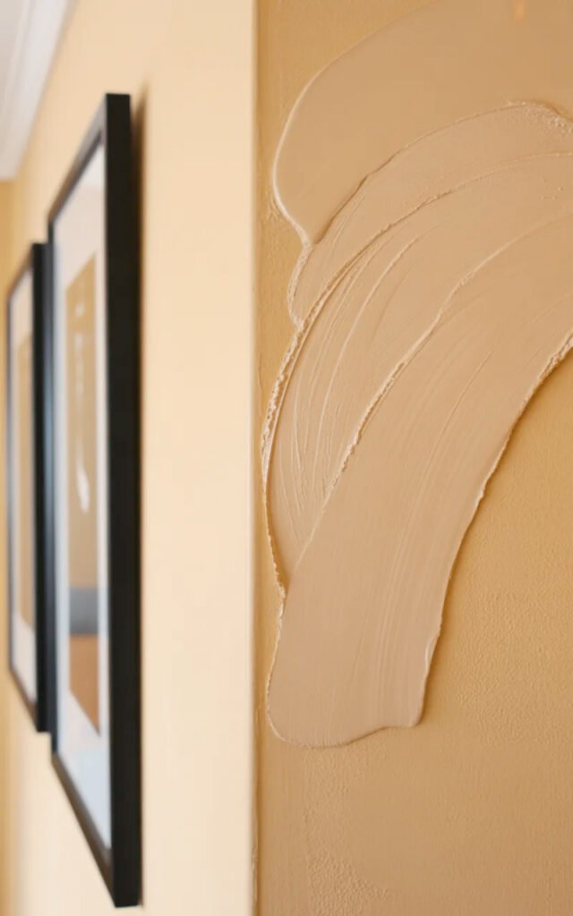 Soft warm cream wall color creating bright welcoming backdrop in tiny entrance space