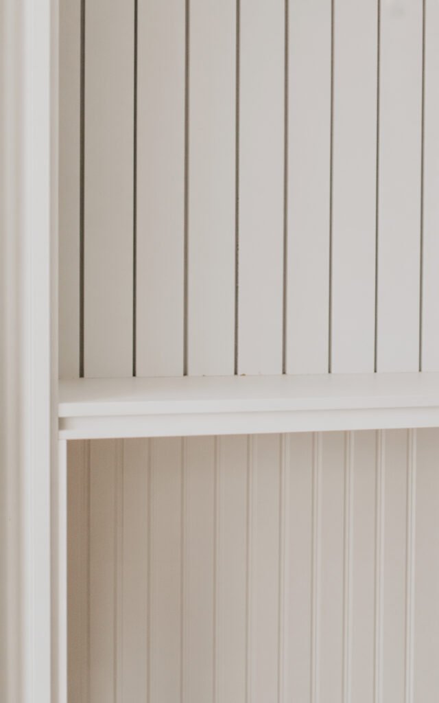 White painted shiplap wall creating textured farmhouse backdrop in entryway